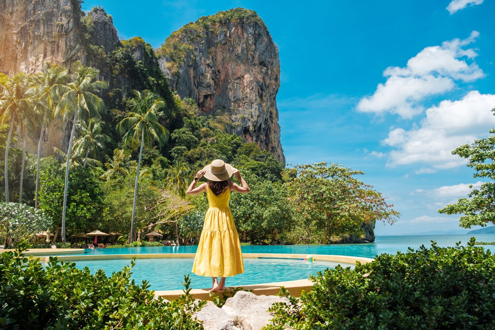 woman-tourist-in-yellow-dress-and-hat-traveling-on-railay-beach-krabi-thailand-vacation-travel.jpg