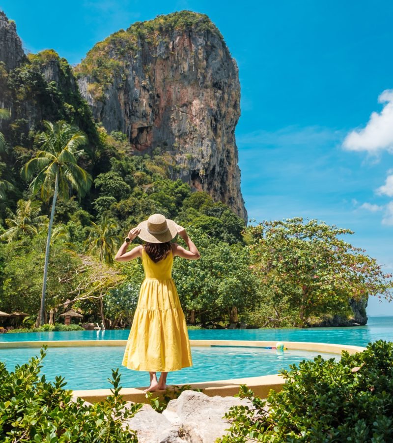 woman-tourist-in-yellow-dress-and-hat-traveling-on-railay-beach-krabi-thailand-vacation-travel.jpg